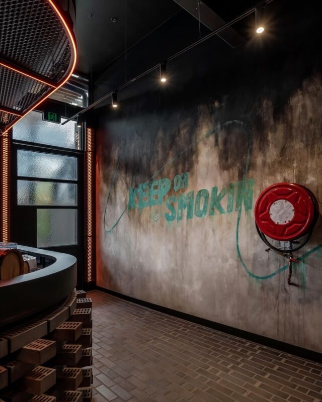 Is this the most tongue-in-cheek placement for a fire hose reel ever? EAT recently completed Up in Smoke's second venue - a diner that specialises in smoked meats and beer (what else could you want..) The interiors used custom wall textures by @scanlanandmakers to evoke the sensations of wood fired cooking - in all its smoky glory.
.
Thanks to our project team @janineniluka and @ashleigh_nw and photos by @chrism.photography 
.
#eatupinsmoke #interiordesign #interiors #Hospitality #hospitalitydesign #melbournehospitality #restaurantdesign #restaurantfitout #brickdetailing